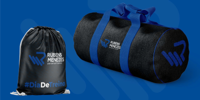 Aplicação da identidade visual de Rubens Menezes em bolsa e mala.